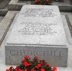 the headstones of two people and flowers in front of them are cement with writing on it