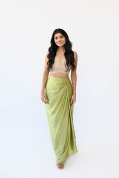 Experience the understated elegance of our Satin Drape Skirt. Crafted with a fitted waistband for a seamless silhouette fit and finished with a timeless drape, this piece is crafted from a luxuriously soft silk satin fabric, perfect for a flowy, feminine look. Features: Zipper and hook closure Fitted waistband High-waisted fit Standard length is typically comfortable for anyone 5'2" to 5'6" Included in purchase: Pista Drape Skirt If you select "custom" as your size option, our team will contact Satin Dhoti Skirt, Side Drape Skirt, Satin Skirt Design, Satin Skirt Outfit Indian, Silk Asymmetrical Draped Skirt With Lining, Saree Skirt Drape, Silk Long Wrap Skirt With Relaxed Fit, Silk Wrap Skirt With Relaxed Fit, Silk Ruched Draped Skirt