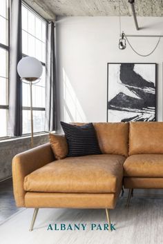 a living room with a couch, chair and pictures on the wall above it that says albany park