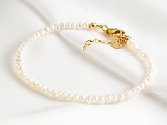 "This beautiful bracelet is easy to wear, and incredibly feminine. It is handmade by us in our atelier, each pearl is carefully selected and hand placed. ▲▽ M A T E R I A L ▽▲ * Sterling Silver (925) * 14k Gold Filled ------------------------------------------------------------- ▲▽ S I Z E ▽▲ * Fits all adjustable bracelet : 16 -18 cm | 6,3\" - 7,1\" * Pearl sizes: ~2 mm ------------------------------------------------------------- ▲▽ G E M ▽▲ * Natural Pearls * High grade pearls --------------- Cheap Round Pearl Bracelets, Affordable Classic Round Pearl Bracelet, Cheap Elegant Round Pearl Bracelet, Cheap Minimalist Pearl Bracelet With Round Beads, Affordable Round Pearl Bracelet Gift, Affordable Round Pearl Bracelet For Birthday, Pearl Strand, Choker Pendant, Back Necklace