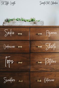 a wooden dresser with writing on the top and bottom drawers labeled in different font styles