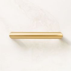 a gold colored handle on a white wall