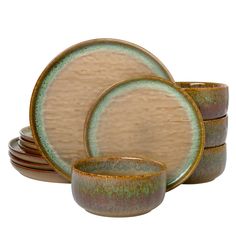 a set of four brown and green dishes