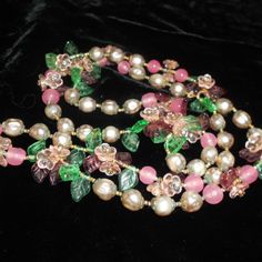 Very Beautiful And Early Miriam Haskell Necklace Designed By Frank Hess, Made In The Early 1940s Era. It Is Still On The Original Stringing With Tiny Brass Beads, Little Glass Flower Petals And Glass Flowers With Little Rhinestones In The Middle, Poured Glass Pink Beads, The Flower Clusters Are Surrounded By Glass Pearls With Brass Fittings On Either End. The Necklace Is Not Signed; Nor Should It Be For This Era. We Know By The Pearls And Fittings It Is Unquestionably Haskell And Frank Hess Desi Pink Flower-shaped Evening Jewelry, Pink Jeweled Necklace For Celebrations, Handmade Pink Necklace For Formal Occasions, Formal Pink Handmade Necklace, Vintage Pink Single Strand Jewelry, Pink Single Strand Glass Necklace, Pink Flower Jewelry For Celebration, Pink Single Strand Jewelry For Party, Pink Single Strand Party Jewelry