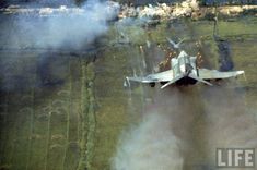 This picture shows an F4-Phantom firing multiple FFAR rockets from the mounted rocketpods into small village known to be an important Vietcong stronghold during the Vietnam War in 1966. The F4 used to have 1 rocketpod and 3-4 Napalm Canisters on each wing. Military Photos, Vietnam Veterans, Life Magazine, Military History