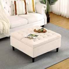 a white couch and ottoman in a living room