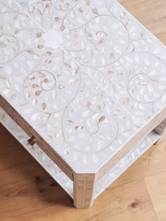 a white table sitting on top of a wooden floor