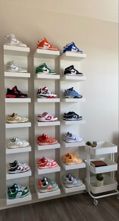 there are many pairs of shoes on the shelves next to each other in this room