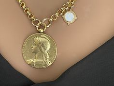 1. Large Old French Medal Replica, Antiqued Gold Coin Pendant, Woman Lady Coin, Rolo chain Necklace, Mother Of Pearl Charm, Toggle Clasp This French medal replica depicts Marianne, who has been the personification of the French Republic since the revolution. She stands for liberty, equality, and reason. length- 20ins. Should you require a different length please contact me. Coin Pendant Length: 42mm Width: 32mm Metal: Pewter Finish: 12k Antiqued GoldBrass Brass/Gold Plated Mother Of Pearl Charm Gold Vintage Charm Chain Necklace, Gold Chain Necklace With Vintage Charm, Vintage Coin Pendant Necklace With Adjustable Chain, Vintage Gold-tone Chain Necklace With Coin Pendant, Vintage Gold Coin Necklace With Chain, Vintage Yellow Gold Coin Necklace With Adjustable Chain, Vintage Coin Necklace With Round Pendant, Vintage Charm Pendant Chain Necklace, Vintage Round Pendant Coin Necklace