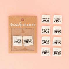 some white paper with black and white hearts on them next to a package of made in 205 stickers