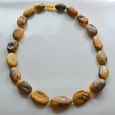 Baltic Amber Necklace Indulge in the timeless elegance of our Antique Colored Rustic Baltic Amber Necklace. This exquisite piece features larger-than-average beads full of Inclusions, each radiating a unique, old-world charm that is both captivating and sophisticated. 23 inches in length, largest focal bead measures 37X22X12mm. Made in Lithuania. You will receive one Necklace, the exact Necklace in the photos. Arrives to your home with the "All About Amber" Brochure which includes care instructions. Spiritual Yellow Hand-strung Necklaces, Spiritual Yellow Hand-strung Necklace, Classic Amber Pendant Necklace, Amber Oval Spiritual Necklace, Spiritual Amber Oval Necklace, Amber Single Strand Spiritual Necklace, Spiritual Oval Amber Necklace, Vintage Adjustable Necklace With Oval Beads, Vintage Necklaces With Adjustable Oval Beads