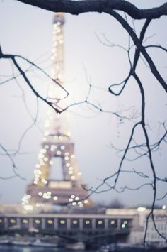 the eiffel tower is lit up at night