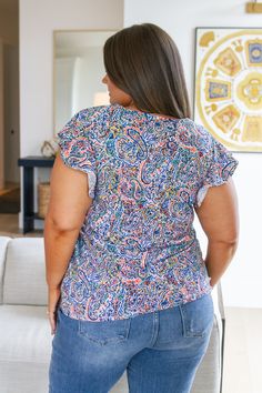 Let the summer breeze caress your look with the Patient in Paisley Flutter Sleeve Top. Boasting lightweight fabric, flutter sleeves, a v-neckline, and a floral paisley print, this top is sure to become an instant wardrobe favorite. Dare to wear something effortless and beautiful - make the Patient in Paisley your go-to this season! Lightweight Woven Good Stretch V-Neckline Flutter Sleeves 92% Polyester, 8% Spandex True to Size S: Chest 35" Length 25"M: Chest 36" Length 26.5"L: Chest 39" Length 26.5"1XL: Chest 44" Length 27"2XL: Chest 46" Length 28"3XL: Chest 48" Length 28" Sarah is wearing a size SKendall is wearing a size 1XL Suggested Pairings: Jones High Rise Cuffed Straight Jeans Pearls and Paperclips Necklace Flowy V-neck Printed Tops, Spring V-neck Paisley Print Tops, Summer Patterned V-neck Tops, Summer V-neck Patterned Tops, Printed Flutter Sleeve Tops For Summer, Flowy Multicolor Flutter Sleeve Tops, Multicolor Flowy Tops With Flutter Sleeve, Printed Flowy V-neck Tops, Summer Vacation Tops With Paisley Print