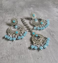 We are thrilled to introduce our exquisite collection of Indian earrings in Silver and Mint blue color. These stunning earrings are crafted to enhance your style, whether you're attending a party or a wedding ceremony. They are guaranteed to make you stand out in the crowd.Elevate your style with these stunning Earrings. Make a bold fashion statement and turn heads wherever you go. Shop our stunning collection today!We have a wide range of colors available, so be sure to check our other listings Turquoise Kundan Earrings For Wedding, Blue Earrings For Diwali, Blue Bollywood Jewelry Sets For Gift, Blue Bollywood Style Jewelry Sets For Gift, Diwali Party Tikka With Matching Earrings, Blue Danglers For Party, Blue Hand Set Earrings For Party, Blue Festive Jewelry Sets For Diwali, Elegant Blue Earrings For Diwali