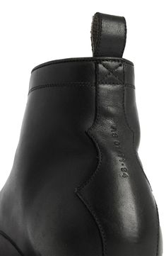 Crisp, monochrome design refines this cap-toe combat boot crafted from premium leather above a rugged rubber sole. 5" shaft Lace-up style Leather upper and lining/synthetic sole Made in Portugal Workwear Combat Boots With Rubber Sole, Plain Toe Combat Boots With Rubber Sole For Work, Urban Leather Waterproof Boots, Leather Waterproof Ankle-high Boots For Streetwear, Leather Cap Toe Chelsea Boots For Work, Leather Moc Toe Boots For Streetwear, Classic Boots With Reinforced Heel For Streetwear, Leather High-top Chelsea Boots For Work, Leather Combat Boots With Goodyear Welt For Work