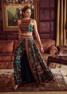 Editor's Note Featuring a classically feminine silhouette, hand painted and printed with floral motifs in vibrant colours. It is intricately adorned with embroidery and coin-work. The skirt is a combination of palazzo pants and wrap around skirt. Fabric: Blouse & lehenga: viscose silk Color: Green Components: Blouse and lehenga Occasion: Wedding Guest and festive Disclaimer: Product color may slightly vary due to photographic lighting sources or your monitor setting. Care: Dry Clean Only About t Western Lehenga Designs Latest, Lehenga Skirt Designs, Palazzo Lehenga, Saree Lengha, Saree Skirt, Delhi Fashion, Skirt Indian, Lehenga And Blouse, Lehenga Dress