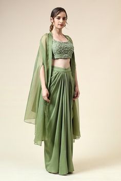 Tropical green blouse embroidered with beads and sequin in floral motifs. Paired with matching draped skirt and cape. - Aza Fashions Green Draped Choli For Reception, Traditional Green Draped Choli, Green Draped Sets With Zari Work, Festive Hand Embellished Green Choli, Designer Green Sequined Blouse Piece, Green Hand Embellished Sets In Traditional Drape, Green Hand Embellished Sets With Traditional Drape, Green Hand Embellished Choli With Traditional Drape, Embellished Green Georgette Pre-draped Saree