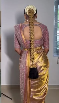 the back of a woman's gold sari