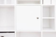 a white bookcase filled with lots of books next to a toilet paper roll and tissue dispenser