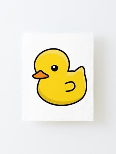 a yellow rubber duck sitting on top of a white surface