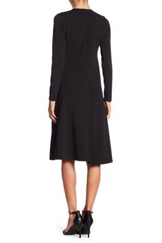 This long sleeve A-line dress is great for the office or dinner and makes for a classy, put-together look. Fit: this style runs small. 43" length (size Small) Crewneck
 Long sleeves A-line skirt 47% polyester, 47% rayon, 6% spandex Machine wash Made in the USA Model stats: 5'10", 32" bust, 25" waist, 36" hip. Model is wearing size Small. Sleek Long Sleeve Dress For Fall, Fitted Long Sleeve Solid Dress For Work, Fitted Long Sleeve Dress For Work, Solid Color Fitted Long Sleeve Dress For Work, Black Long Sleeve Business Dress, Formal Sleek Long Sleeve Fall Dress, Sleek Long Sleeve Evening Dress For Fall, Fitted A-line Long Sleeve Dress For Fall, Fall A-line Midi Dress With Flattering Silhouette