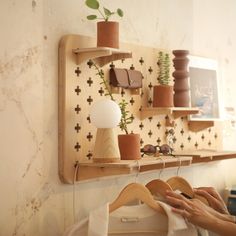 a woman is sewing on a wooden shelf