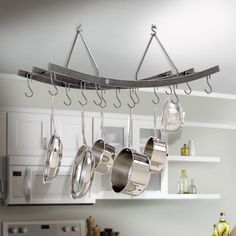 pots and pans hanging from a kitchen rack