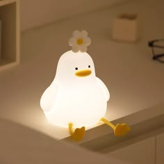 a light that is on top of a table with a chicken in it's head