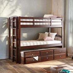 a wooden bunk bed with drawers underneath it