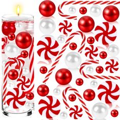 red and white christmas decorations next to a tall glass filled with water, candy canes and balls