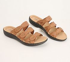 Easy to slide on and off, these leather sandals are summer's best friend. From Clarks Footwear. Adjustable Leather Slippers, Leather Slide Clogs For Summer, Spring Slippers With Leather Footbed, Adjustable Leather Footbed Slippers For Summer, Open Toe Mules For Summer Outings, Leather Flip Flops For Summer Outings, Leather Open Toe Flip Flops For Summer, Leather Open Toe Flip Flops For Summer Outings, Comfortable Cushioned Sandals For Summer Outings