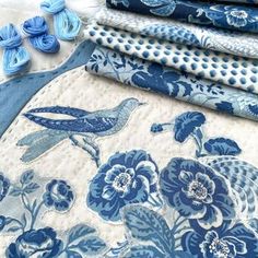 several blue and white fabrics laid out on top of each other