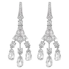 Step back in time with the elegance and allure of our antique briolette diamond dangle earrings. Delicately handcrafted in 18 karat white gold, these earrings exhibit a masterful blend of vintage design and modern craftsmanship. Each earring gracefully cascades with three meticulously cut briolette diamonds, artfully suspended to capture and amplify light with every subtle movement. In total, the briolette diamonds weigh an exceptional 3.22 carats. Enhancing their brilliance and lending a lumino Luxury Briolette Diamond Earrings, Luxury Briolette Pearl Earrings Elegant, Luxury White Gold Briolette Earrings, Classic White Gold Diamond Chandelier Earrings, Classic Brilliant Cut Chandelier Earrings For Anniversary, Formal Rose Cut Diamond Chandelier Earrings, Formal Diamond White Chandelier Earrings For Pierced Ears, Formal White Gold Briolette Earrings, Formal Chandelier Earrings With Rose Cut Diamonds