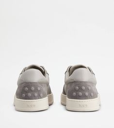 A sporty and sophisticated taste characterizes these sneakers with basketball-inspired upper, and side Tod's logo. Crafted in calfskin suede with smooth leather inserts, they come with a rubber outsole with embossed rubber pebbles. Grey Sneakers, Back To Black, Smooth Leather, Grey And White, Calf Skin, Basketball, Sneakers, Grey, 10 Things