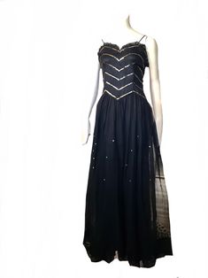 "this is an amazing vintage 1930s 40s art deco formal glamour evening cocktail party gown  this spectacular dress features a fitted bodice,  sleeveless with black shoulder straps. a long flowing net sheer skirt with underskirt. the bodice is adorned with beautiful sparkly gold sequins in a striped pattern and the front of the skirt has the same gold sequins scattered around on the middle section. the neckline is adorned with cute black ruffle trim. hook and eye closures on the side bodice this d 1920s Style Black Evening Dress, 1920s Fitted Dress For Night Out, Fitted Art Deco Party Dresses, 1920s Black Cocktail Dress, Fitted 1920s Style Dress For Night Out, Gatsby Style Floor-length Party Dress, Art Deco Black Cocktail Dress, Fitted Gatsby Style Prom Dresses, Black Art Deco Cocktail Dress