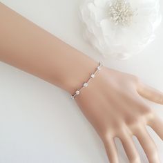 "A dainty and simple wedding bracelet with round cubic zirconia crystals. The sparkling cubic zirconia stones add a subtle sparkle to your wedding jewelry. Material used is quality rhodium plated brass, also available in rose gold finish and 14k gold finish. A versatile bracelet that can be used for many occasions!   # Bracelet is available in 6\", 6.5\" or 7 inches, 4 mm wide. Please select length in the drop down menu. Matching Ginger Collection https://www.etsy.com/au/shop/poetryjewelry?search_query=ginger POLICIES All shipping and return information listed here: https://www.etsy.com/au/shop/poetryjewelry?ref=listing-shop2-all-items-count#policies FAQ https://www.etsy.com/au/shop/poetryjewelry?ref=listing-shop2-all-items-count#more-section To see more beautiful handcrafted jewelry by me Minimalistic Bracelet, Rose Gold Jewelry Set, Wedding Jewelry Simple, Gold Bracelet Wedding, Wedding Jewelry For Bride, Light Gold Color, Pearl Drop Necklace, Rose Gold Pearl, Gold Jewelry Sets