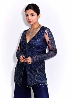 Dive into refined elegance with this midnight blue tonal hand-embroidered full sleeves kurta ensemble! Adorned with intricate hand embroidery, this kurta exudes sophistication and grace. Paired with georgette flared pants, it offers a contemporary yet timeless silhouette. Complete your look with a matching net dupatta for added charm. Step into effortless sophistication with this captivating attire, perfect for making a statement at any special occasion. Designer Long Sleeve Sharara For Navratri, Semi-stitched Long Sleeve Bandhgala With Mirror Work, Designer Long Sleeve Sharara For Eid, Designer Long Sleeve Sharara For Diwali, Blue Palazzo Set With Intricate Embroidery And Long Sleeves, Blue Palazzo Set With Intricate Embroidery, Blue Bollywood Bandhgala With Mirror Work, Blue Long Sleeve Palazzo Set With Intricate Embroidery, Formal Long Sleeve Kurta With Mirror Work