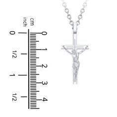 Made in sterling silver, this meaningful crucifix necklace is a beautiful symbol of faith. Classic Engraved Crucifix Cross Necklace, Classic Polished Crucifix Cross Necklace, Sterling Silver Crucifix Necklace In Spiritual Style, Sterling Silver Spiritual Crucifix Necklace, White Gold Sterling Silver Crucifix, Spiritual Sterling Silver Crucifix Necklace, Elegant Sterling Silver Crucifix Jewelry And Charms, Sterling Silver Crucifix Necklace With Polished Finish, White Gold Crucifix Necklace With Polished Finish