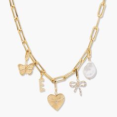 Introducing our Cami Initial Charm Necklace! Your choice of initial charm paired with a pearl, bow, heart, and butterfly charm, all on a large an elongated link paperclip chain necklace. Stand out from the crowd with this unique accessory! Available in 14k gold plated brass Palmer Initial Charm: 5/8" tall, width varies Cami Butterfly Charm: 13/16"x 5/8" Cami Heart Charm: 3/5"x 13/16" with 2 mm round cubic zirconia stone Cami Bow Charm: 3/5"x 11/16" with 1.5mm x 3mm cubic zirconia baguette stones Tennis Jewelry, Modern Jewellery Design, Bow Charm, Paperclip Chain Necklace, Pearl Bow, Necklace Stand, Gold G, Charm Necklace Silver, Gold Charm Necklace