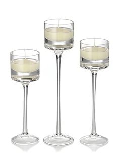 three empty wine glasses sitting next to each other