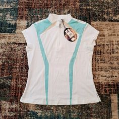 a women's white shirt with blue stripes on the bottom and a pair of sunglasses hanging from it