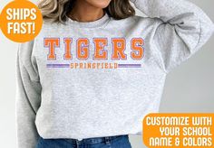 Stay cozy and show your team pride with our Custom Team Mascot Sweatshirt! Perfect for game days, casual outings, or lounging at home Crafted from high-quality, ultra-soft fabric, this sweatshirt offers unbeatable comfort and warmth. It's customizable with your choice of colors and team/city name, making it a unique and personal piece of fan gear. Whether you're cheering from the stands or representing your team around town, this versatile sweatshirt is a stylish way to display your loyalty. It's also an excellent gift for sports enthusiasts who love to support their favorite team in comfort and style. Order your custom Comfort Colors sweatshirt today and celebrate your team spirit with flair! Production Time: 1-3 business days Shipping Time: 2-5 business days We GUARANTEE all of our produ Team-colored Sports Sweatshirt, Team-colored Sweatshirt For Sports, Collegiate Sweatshirt With Team Logo, Varsity Sweatshirt With University Logo For Game Day, Sporty University Logo Sports Tops, Collegiate T-shirt With Ribbed Cuffs And Relaxed Fit, Collegiate T-shirt With Ribbed Cuffs In Relaxed Fit, Collegiate Style Relaxed Fit T-shirt With Ribbed Cuffs, Sporty College Sweatshirt With Team Logo