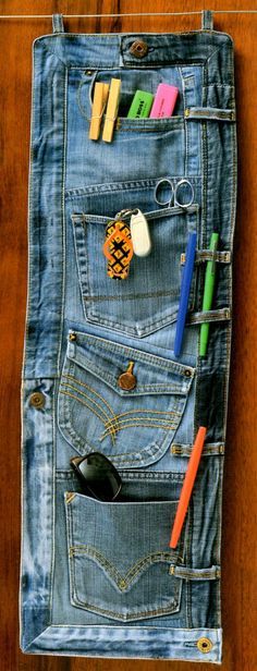 a denim pocket with pens, scissors and other items in it