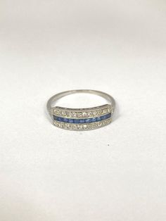 a white gold ring with blue and white diamonds