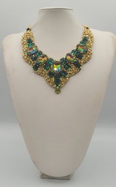 Each piece of our statement necklaces is handmade and one of a kind made in Italy. Our creations is made of high quality materials such as crystals and rhinestones. Each embroidered material is carefully hand sewn. Very glamorous and stylish. Perfect gift to someone you like. Materials Strass stone and Rhinestone in Emerald, Rainbow and Peridot  color in different dimension.  Black satin fabric backing. Aluminium chain with lobster closure. Measurements Weight approximate 200 grams. Chain lenght 25 cm - 9.84 in Circumference approximate 63 cm - 24.80 in Feel free to contact us if you have any question. Thank you so much for looking at our shop and our articles each of them, single piece. Handmade Crystal Necklaces For Parties, Luxury Handmade Multicolor Necklaces, Luxury Handmade Multicolor Necklace, Handmade Pendant Necklace For Party, Handmade Long Bib Necklace For Party, Unique Jeweled Necklaces, Jeweled Choker Necklaces For Celebration, Unique Jeweled Necklace For Party, Unique Beaded Pendant Necklaces For Parties