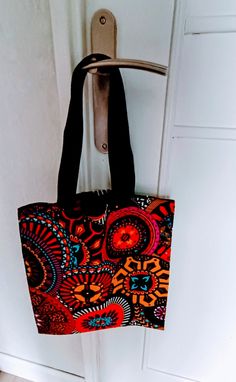 Tote bag in real African wax fabric. It measures 40 cm in height 35 cm wide And the webbing handles measure 52 cm. They are reinforced by a cross stitching on the bag (see Photo) Large Canvas Bags With Handles, Large Canvas Bag With Handles, Black Square Canvas Bag For Errands, Black Rectangular Cotton Bag, Black Rectangular Cotton Bags, Black Square Canvas Shoulder Bag, Black Cotton Rectangular Bag, Black Square Canvas Bag For Daily Use, Black Rectangular Canvas Bag With Top Carry Handle