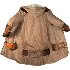 a child's star wars costume is shown in full length and has brown leather sleeves