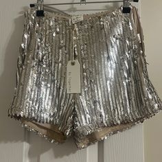 Side Zip Sequin Shorts. Metallic Shimmer Bottoms For Summer, Metallic Shimmer Summer Bottoms, Metallic Sequined Bottoms For Summer, Silver Sequined Bottoms For Night Out, Metallic Sequined Bottoms For Spring, Glamorous Silver Bottoms For Party Season, Silver Shimmer Bottoms For Party Season, High Waist Silver Bottoms For Party, Silver High Waist Party Bottoms