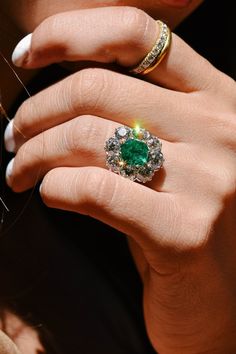 This antique Victorian emerald and diamond ring is a true gem circa 1889. Taking centerstage is an approximately 2.70 carat GIA certified Colombian emerald, displaying a captivating green hue with moderate clarity enhancement. Surrounding the emerald are chunky old European cut diamonds, totaling approximately 4.95 carats in a range of I to J color and SI2 clarity. The ensemble creates a mesmerizing cluster design. This exceptional ring is crafted in silver and 18k yellow gold. While we typicall Cluster Engagement Rings, Erstwhile Jewelry, Victorian Engagement Rings, Diamond Cluster Engagement Ring, Cluster Engagement Ring, Dream Engagement Rings, Antique Engagement, Emerald Engagement Ring, Emerald Jewelry