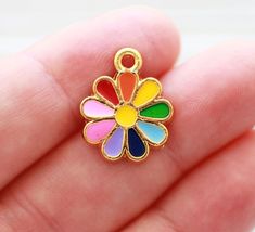 Flower charm in rainbow colors, gold Summer charms, necklace, bracelet, earrings dangle, enamel floral pendant, rainbow daisy pendant 19mm x 16mm More charms and beads?  https://www.etsy.com/shop/EastVillageSupply?ref=seller-platform-mcnav&section_id=18473488 More of flower findings? Just click the link below:  https://www.etsy.com/shop/EastVillageSupply/items?ref=hdr_shop_menu&search_query=flower Would you like to see evil eye findings? Just click the link below:  https://www.etsy.com/shop/EastVillageSupply?ref=seller-platform-mcnav&section_id=18519162 Check out all enamel findings below:  https://www.etsy.com/shop/EastVillageSupply?ref=hdr_shop_menu&search_query=enamel -Actual colors of any item or natural stones may slightly differ from screen to screen due to the screen resolution.  -I Multicolor Flower Pendant Jewelry With Charm, Multicolor Flower Pendant Jewelry With Flower Charm, Rainbow Flower-shaped Jewelry For Gifts, Rainbow Enamel Jewelry As Gift, Rainbow Enamel Jewelry For Gifts, Rainbow Enamel Jewelry For Gift, Rainbow Enamel Jewelry Gift, Multicolor Dainty Jewelry With Flower Charm, Multicolor Enamel Charm Necklaces